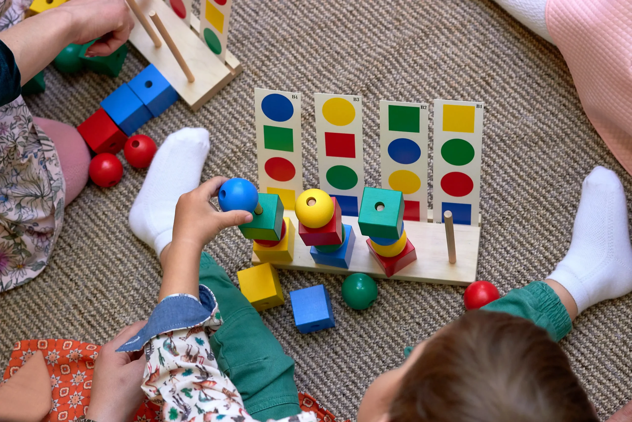 child-playing-with-colorful-wooden-shape-sorter-to-2026-01-11-08-18-10-utc